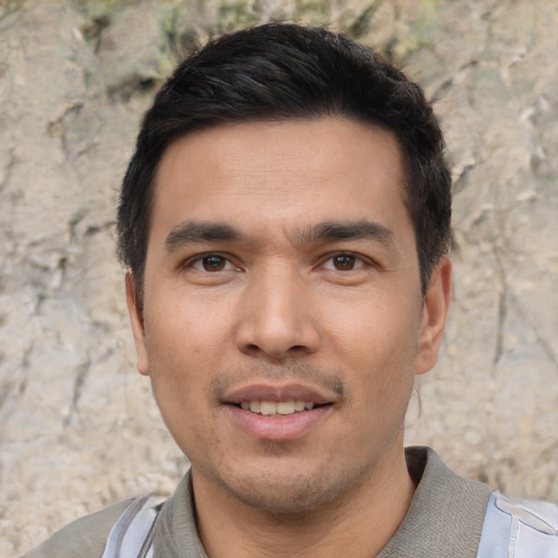 Joyful white young-adult male with short  black hair and brown eyes