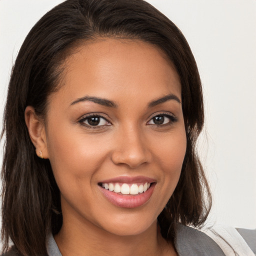 Joyful white young-adult female with long  brown hair and brown eyes