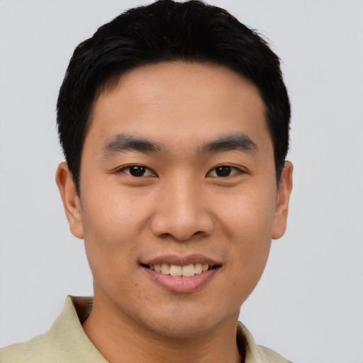 Joyful asian young-adult male with short  black hair and brown eyes