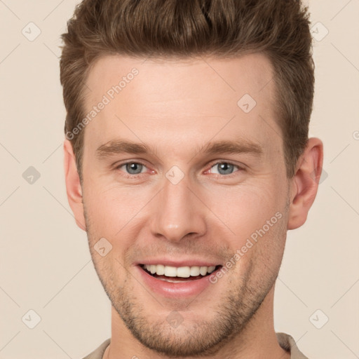 Joyful white young-adult male with short  brown hair and grey eyes