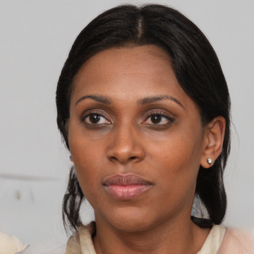 Neutral black adult female with medium  black hair and brown eyes