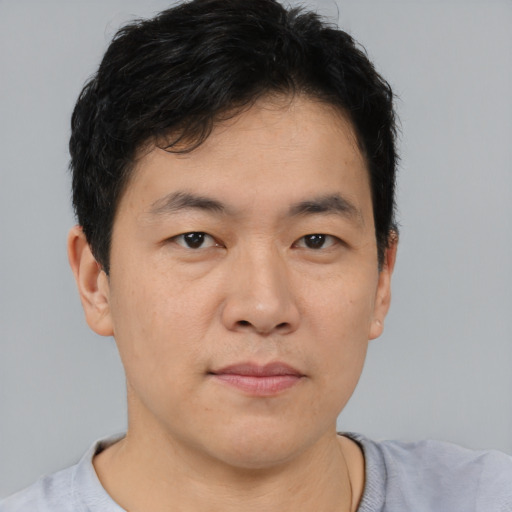 Neutral asian young-adult male with short  brown hair and brown eyes