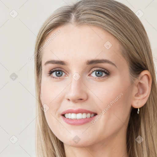 Joyful white young-adult female with long  brown hair and grey eyes