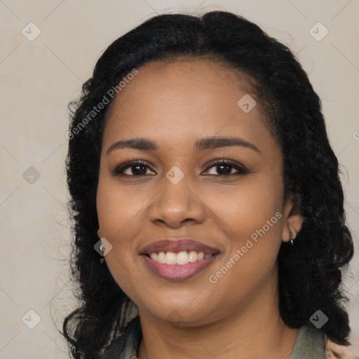 Joyful black young-adult female with long  black hair and brown eyes