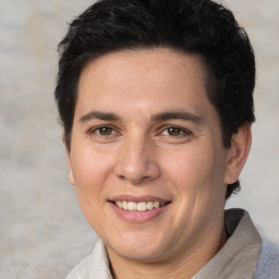 Joyful white adult male with short  brown hair and brown eyes