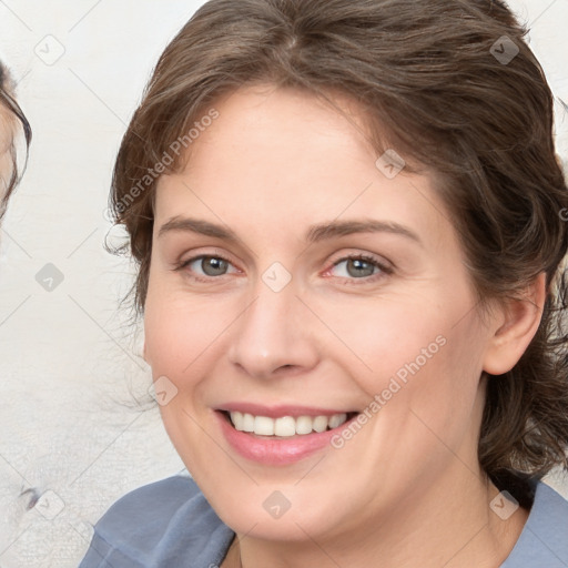 Joyful white young-adult female with medium  brown hair and blue eyes