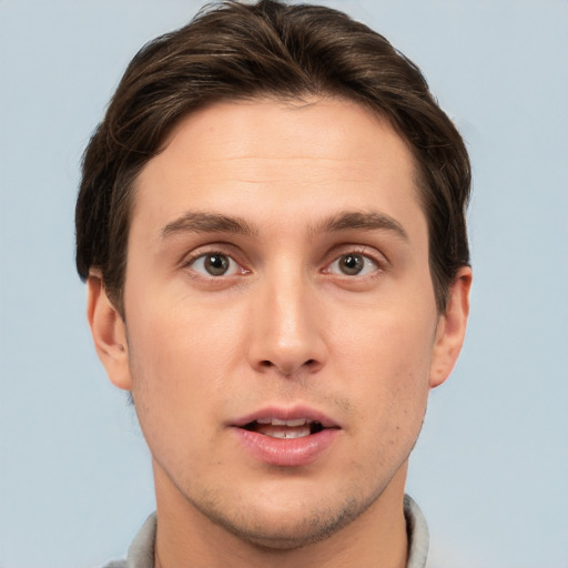 Joyful white young-adult male with short  brown hair and brown eyes