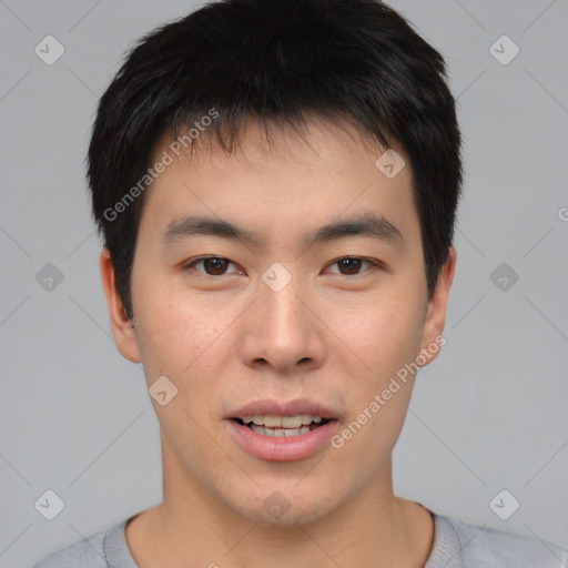 Joyful asian young-adult male with short  brown hair and brown eyes