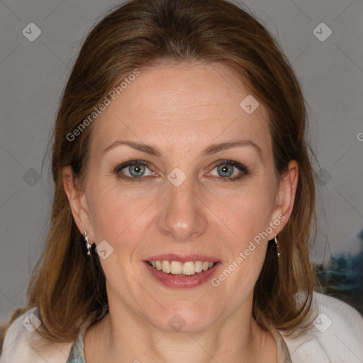 Joyful white adult female with medium  brown hair and blue eyes