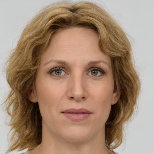 Joyful white young-adult female with medium  brown hair and green eyes