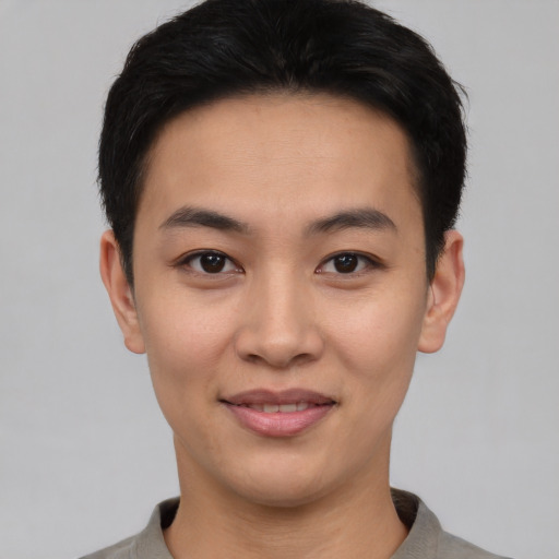 Joyful asian young-adult male with short  black hair and brown eyes
