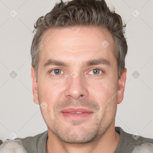 Joyful white adult male with short  brown hair and grey eyes