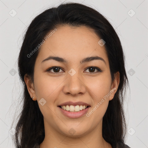 Joyful latino young-adult female with long  brown hair and brown eyes