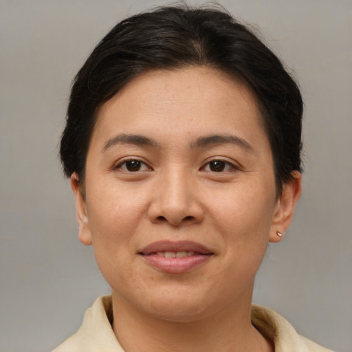 Joyful asian young-adult female with short  brown hair and brown eyes