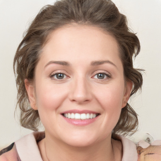 Joyful white young-adult female with medium  brown hair and blue eyes