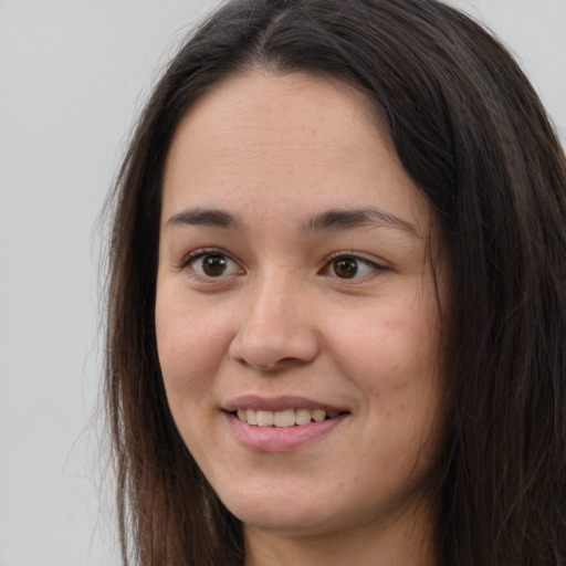 Joyful asian young-adult female with long  brown hair and brown eyes
