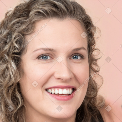 Joyful white young-adult female with long  brown hair and green eyes