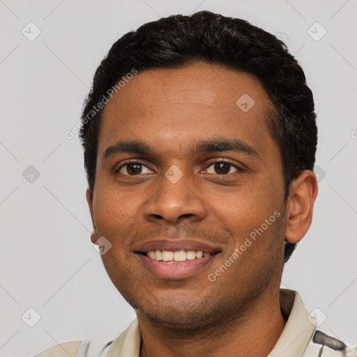 Joyful black young-adult male with short  black hair and brown eyes