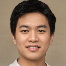 Joyful asian young-adult male with short  black hair and brown eyes