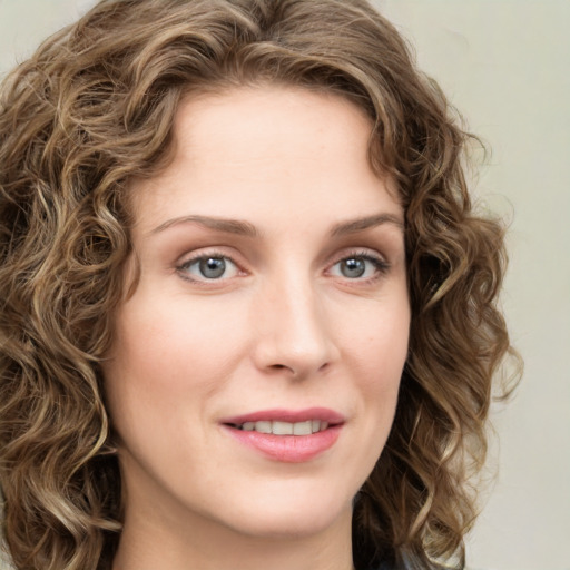 Joyful white young-adult female with long  brown hair and green eyes