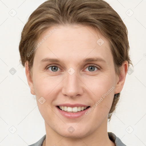 Joyful white young-adult female with short  brown hair and grey eyes