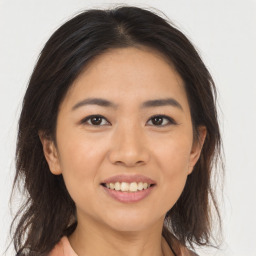 Joyful asian young-adult female with medium  brown hair and brown eyes