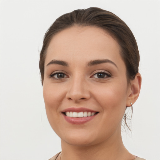 Joyful white young-adult female with medium  brown hair and brown eyes