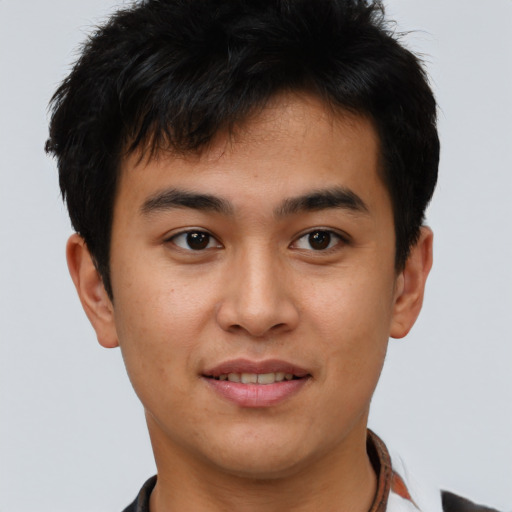 Joyful asian young-adult male with short  brown hair and brown eyes
