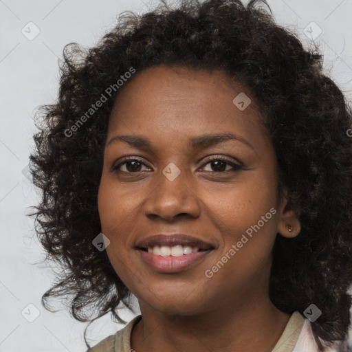 Joyful black young-adult female with long  brown hair and brown eyes