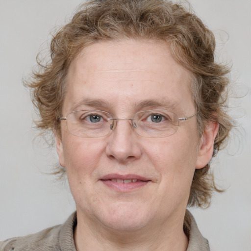 Joyful white middle-aged female with medium  brown hair and grey eyes