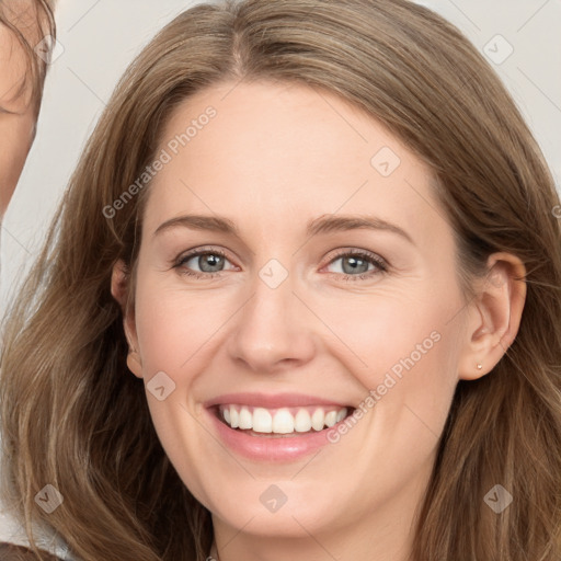 Joyful white young-adult female with long  brown hair and grey eyes