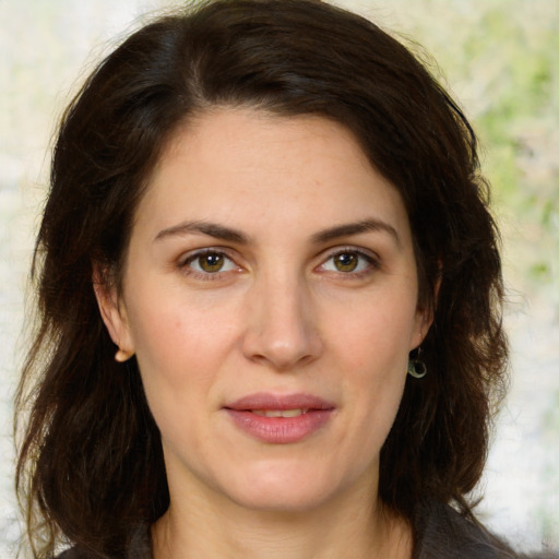 Joyful white adult female with long  brown hair and brown eyes