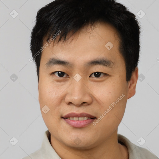 Joyful asian young-adult male with short  black hair and brown eyes