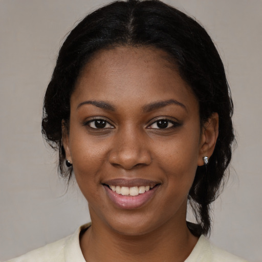 Joyful black young-adult female with medium  black hair and brown eyes