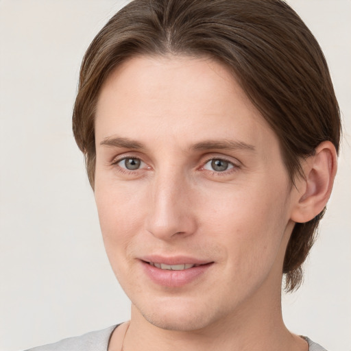 Joyful white young-adult female with short  brown hair and grey eyes