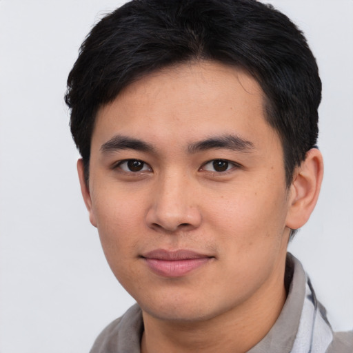 Joyful asian young-adult male with short  black hair and brown eyes