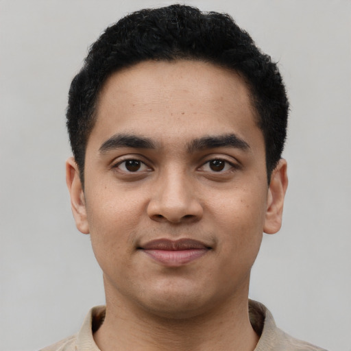 Joyful latino young-adult male with short  black hair and brown eyes