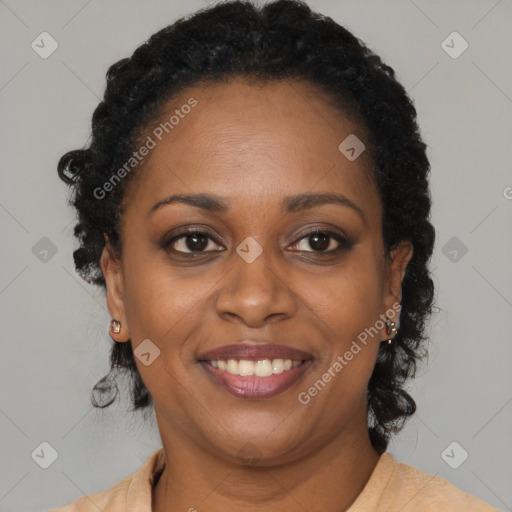 Joyful black adult female with long  black hair and brown eyes