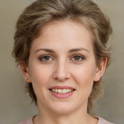 Joyful white young-adult female with medium  brown hair and green eyes