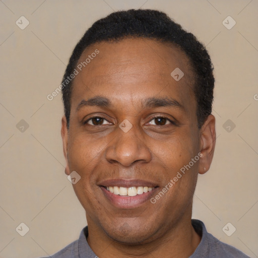 Joyful black adult male with short  black hair and brown eyes