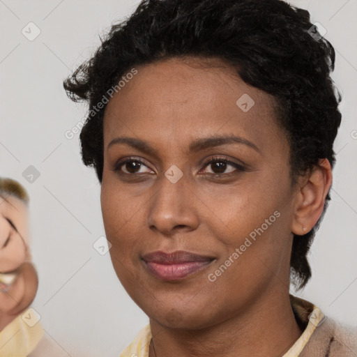 Joyful black young-adult female with short  brown hair and brown eyes