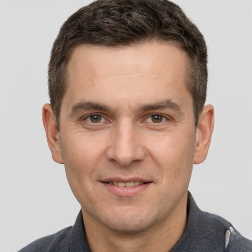 Joyful white adult male with short  brown hair and brown eyes