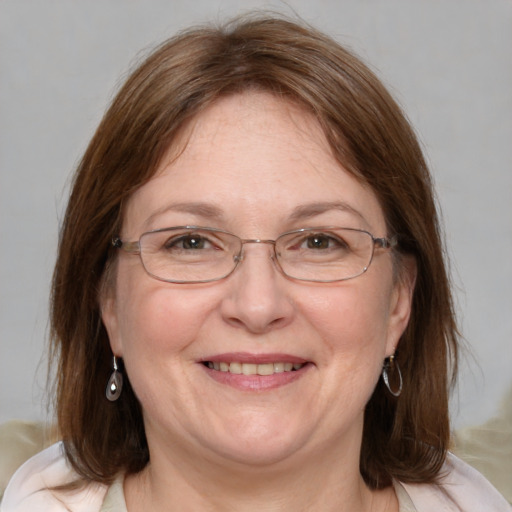 Joyful white adult female with medium  brown hair and blue eyes