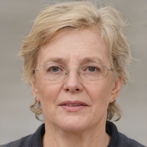 Joyful white middle-aged female with medium  brown hair and grey eyes