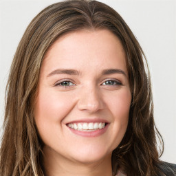 Joyful white young-adult female with long  brown hair and green eyes