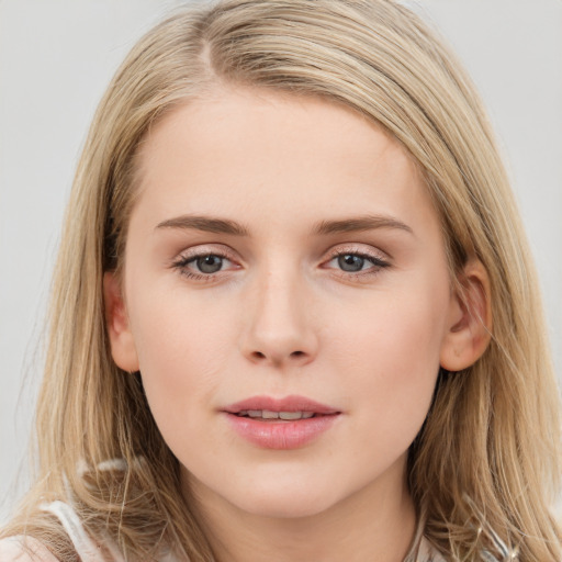 Joyful white young-adult female with long  brown hair and blue eyes