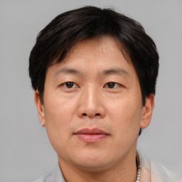 Neutral asian adult male with short  brown hair and brown eyes