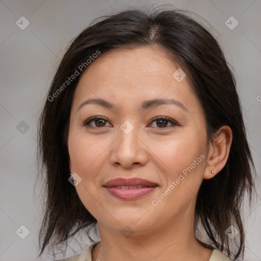 Joyful white adult female with medium  brown hair and brown eyes