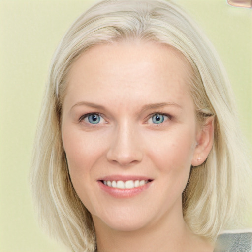 Joyful white young-adult female with medium  blond hair and blue eyes