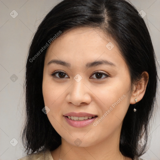 Joyful asian young-adult female with long  brown hair and brown eyes